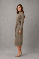 Women’s turtleneck knitted sweater dress with decorative button neckline, long sleeves and adjustable tie waist for autumn and winter.