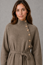 Women’s turtleneck knitted sweater dress with decorative button neckline, long sleeves and adjustable tie waist for autumn and winter.