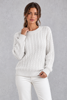 Women's cable-knit round-neck jumper in White – front view
