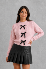 Women’s cable knit cardigan with feminine bow tie front, long sleeves and textured knitted design for autumn and winter layering.