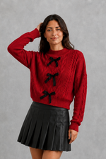 Women’s cable knit cardigan with feminine bow tie front, long sleeves and textured knitted design for autumn and winter layering.