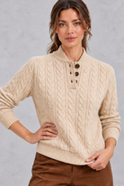 Women's khaki cable knit jumper – close-up of buttoned henley collar and cable pattern