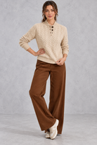 Women's khaki cable knit button neck jumper with brown wide leg trousers – full-length view