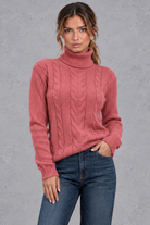 Women's cable knit roll neck jumper in Rose – front view