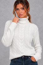 Women's cable knit roll neck jumper in White – front close-up