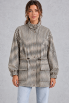 Women’s checked utility field jacket with a high stand collar, adjustable drawstring waist, multiple front pockets and elasticated cuffs.