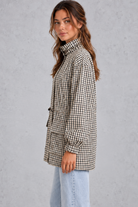Women’s checked utility field jacket with a high stand collar, adjustable drawstring waist, multiple front pockets and elasticated cuffs.