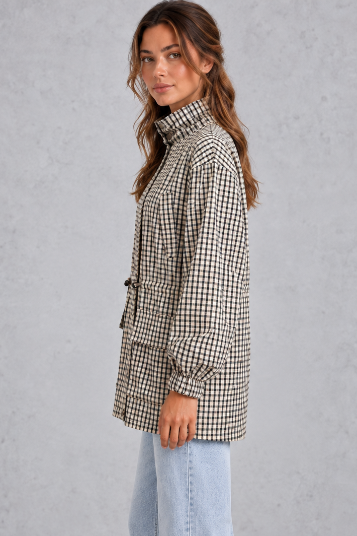 Women’s checked utility field jacket with a high stand collar, adjustable drawstring waist, multiple front pockets and elasticated cuffs.