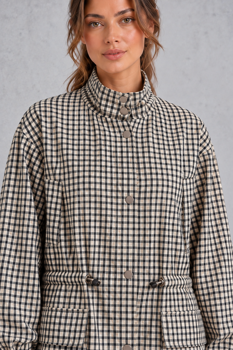 Women’s checked utility field jacket with a high stand collar, adjustable drawstring waist, multiple front pockets and elasticated cuffs.