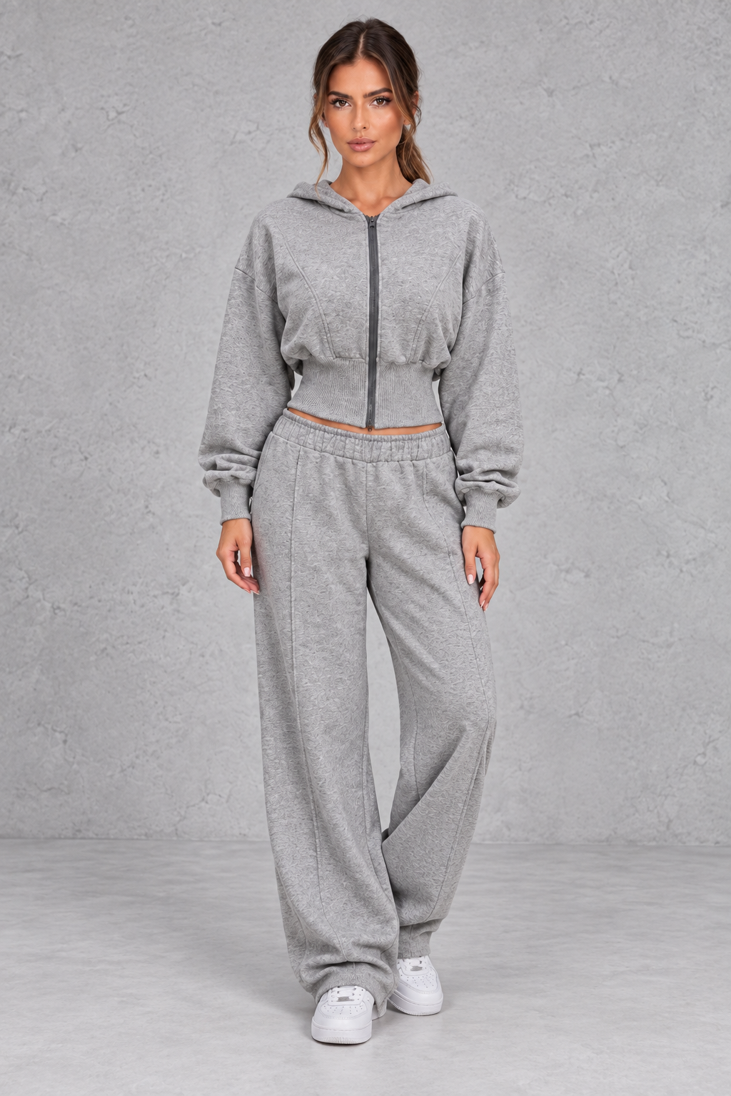 Shop this women’s cinched waist hoodie and wide leg jogger set with a relaxed fit and grey marl finish. Perfect for travel, lounging and casual everyday wear.