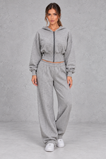 Shop this women’s cinched waist hoodie and wide leg jogger set with a relaxed fit and grey marl finish. Perfect for travel, lounging and casual everyday wear.