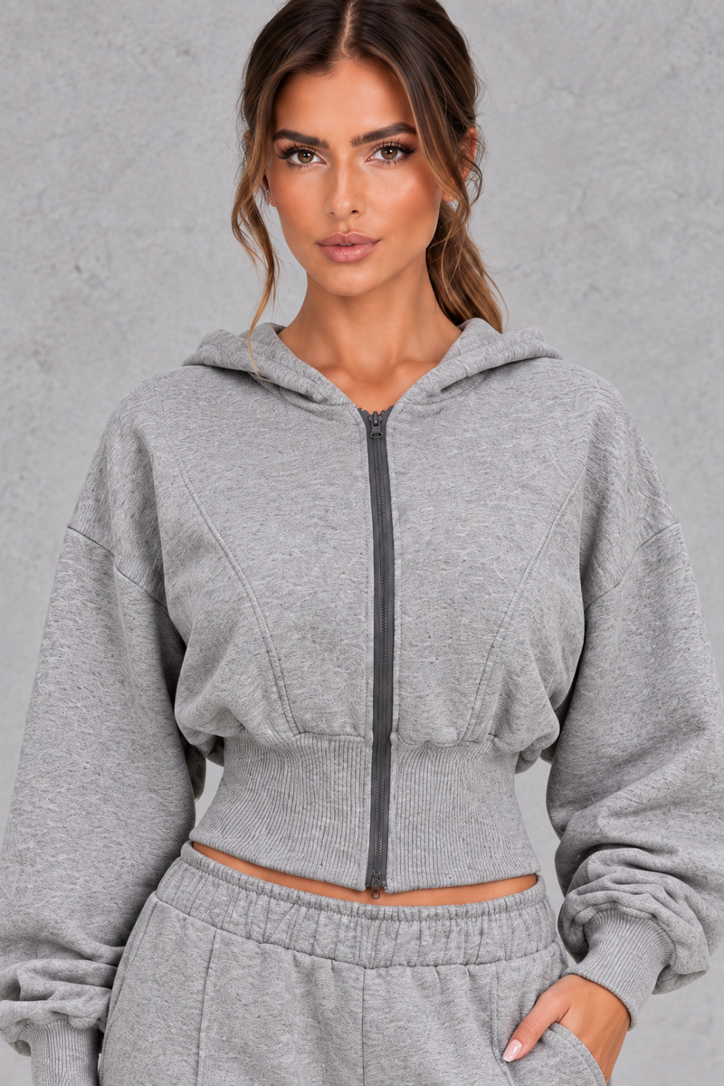 Shop this women’s cinched waist hoodie and wide leg jogger set with a relaxed fit and grey marl finish. Perfect for travel, lounging and casual everyday wear.