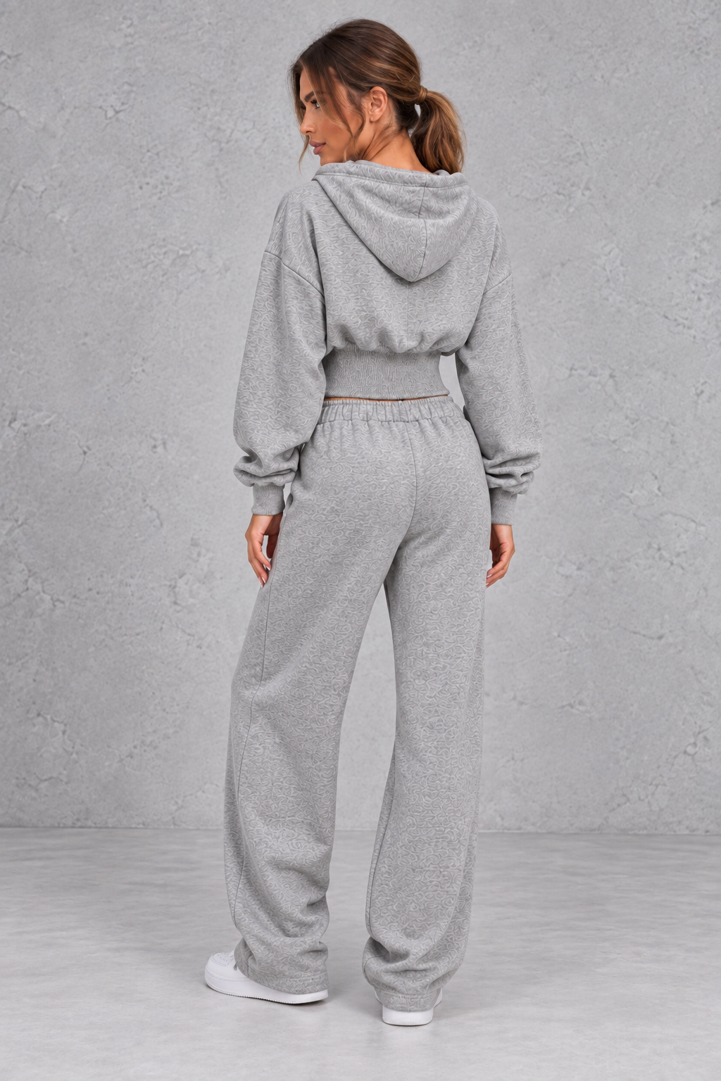Shop this women’s cinched waist hoodie and wide leg jogger set with a relaxed fit and grey marl finish. Perfect for travel, lounging and casual everyday wear.