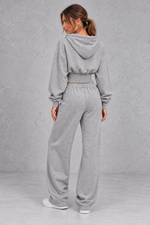 Shop this women’s cinched waist hoodie and wide leg jogger set with a relaxed fit and grey marl finish. Perfect for travel, lounging and casual everyday wear.