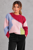 Women's patchwork cable knit jumper in Pink – front view
