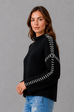 Women’s oversized black crew neck knit jumper with white contrast stitch detailing across the shoulders and long sleeves.