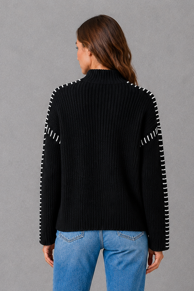 Women’s oversized black crew neck knit jumper with white contrast stitch detailing across the shoulders and long sleeves.