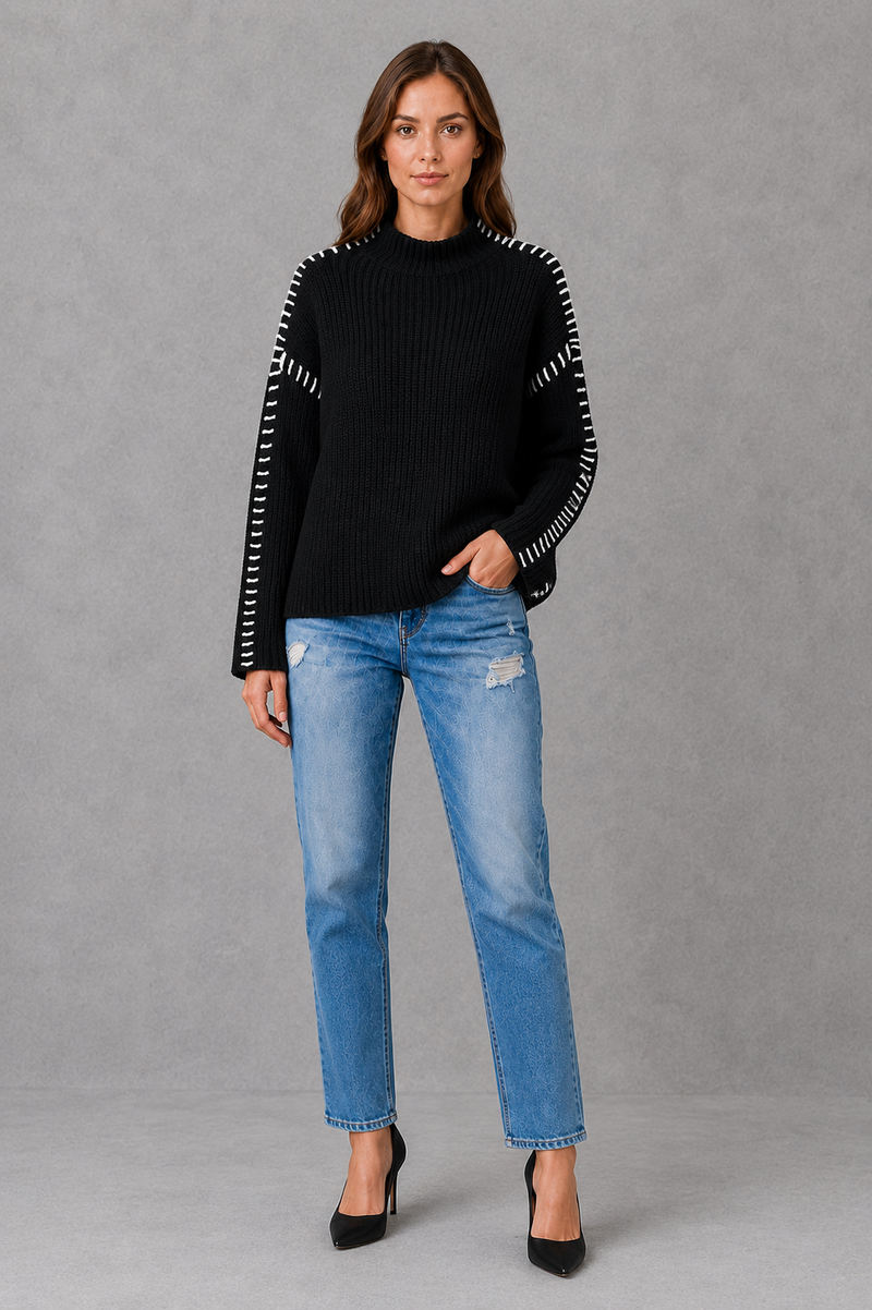 Women’s oversized black crew neck knit jumper with white contrast stitch detailing across the shoulders and long sleeves.