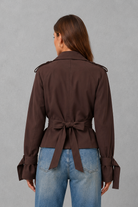 Women’s cotton short trench jacket with double-breasted button front, notch lapels, long sleeves and adjustable belted waist.