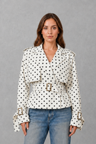 Women’s cotton short trench jacket with double-breasted button front, notch lapels, long sleeves and adjustable belted waist.