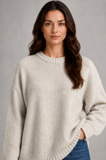 Light grey women’s crew neck knit jumper with an oversized relaxed fit, dropped shoulders and loose wide long sleeves.