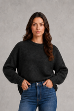 Light grey women’s crew neck knit jumper with an oversized relaxed fit, dropped shoulders and loose wide long sleeves.