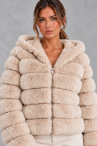 Women’s cropped faux fur winter jacket with a plush hood, horizontal panelled detailing, long sleeves and a voluminous silhouette.