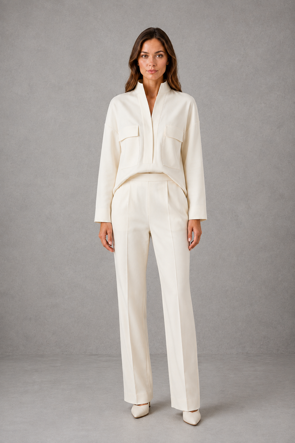 Women’s cropped V-neck jacket and high-waisted cigarette trouser two-piece set with chest patch pockets and a smart casual tailored silhouette.