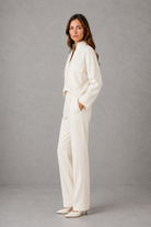 Women’s cropped V-neck jacket and high-waisted cigarette trouser two-piece set with chest patch pockets and a smart casual tailored silhouette.