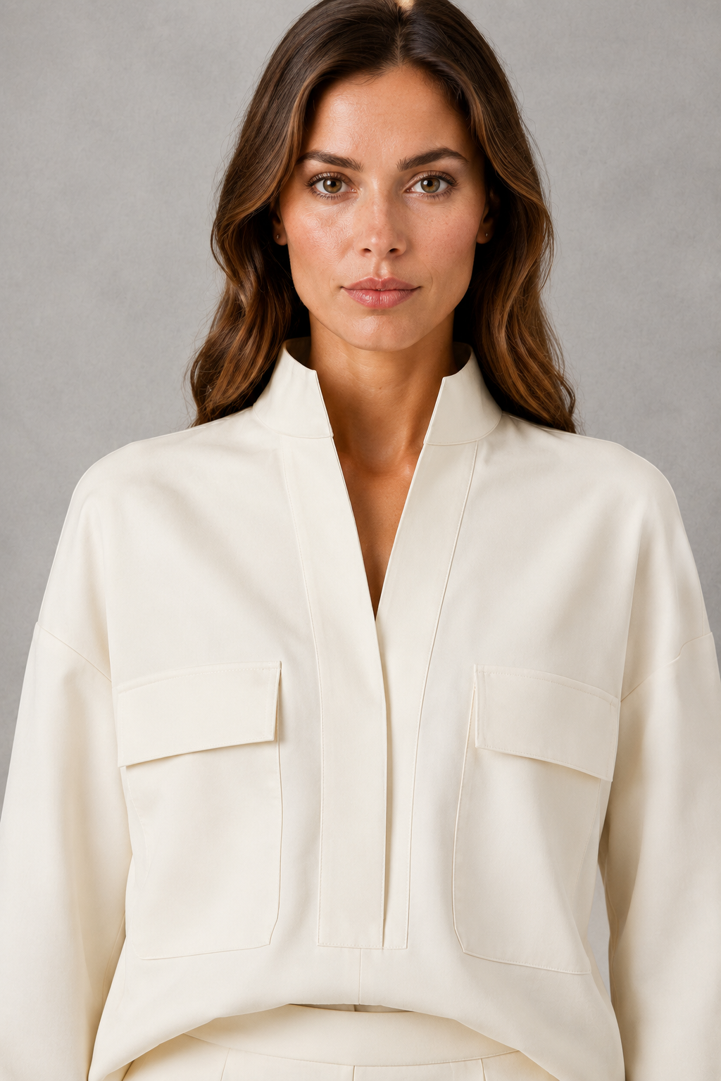 Women’s cropped V-neck jacket and high-waisted cigarette trouser two-piece set with chest patch pockets and a smart casual tailored silhouette.