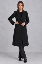 Women's double-breasted longline coat in Black – front view