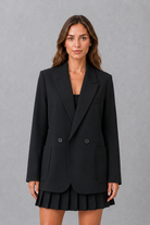 Women’s oversized double breasted blazer with wide peak lapels, structured shoulders, front patch pockets and a classic tailored silhouette.