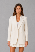 Women’s oversized double breasted blazer with wide peak lapels, structured shoulders, front patch pockets and a classic tailored silhouette.
