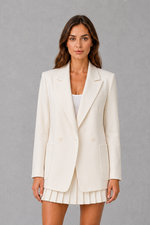 Women’s oversized double breasted blazer with wide peak lapels, structured shoulders, front patch pockets and a classic tailored silhouette.