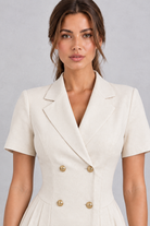 Women’s double-breasted midi dress with a smart lapel collar, short sleeves, button detailing and an elegant A-line silhouette.