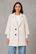 Women’s elegant longline coat with a classic tailored silhouette and lightweight finish, ideal for polished spring and autumn layering.