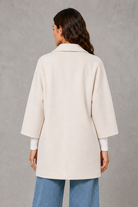 Women’s elegant longline coat with a classic tailored silhouette and lightweight finish, ideal for polished spring and autumn layering.