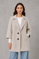 Women’s elegant longline coat with a classic tailored silhouette and lightweight finish, ideal for polished spring and autumn layering.