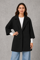 Women’s elegant longline coat with a classic tailored silhouette and lightweight finish, ideal for polished spring and autumn layering.
