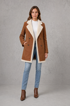 Women’s elegant double-breasted winter coat with a suede-look exterior and cosy shearling-style lining.