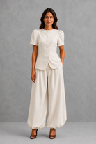 Women’s elegant two piece trouser set with tailored top and ankle-length balloon leg trousers.