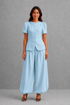 Women’s elegant two piece trouser set with tailored top and ankle-length balloon leg trousers.