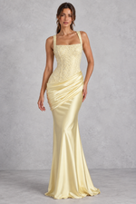 Women’s embellished corset satin maxi dress with square neckline, lace-up back, asymmetric pleated hip draping and flared hem.