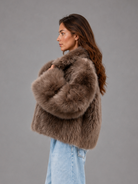 Women’s oversized faux fur coat with a soft plush texture, statement collar and relaxed silhouette for elegant autumn and winter styling.
