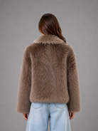 Women’s oversized faux fur coat with a soft plush texture, statement collar and relaxed silhouette for elegant autumn and winter styling.