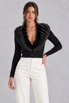 Women’s ribbed knit cardigan with a plush faux fur collar, deep V-neckline, button front and fitted cropped silhouette.