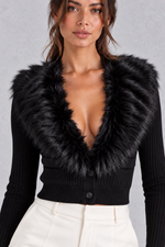 Women’s ribbed knit cardigan with a plush faux fur collar, deep V-neckline, button front and fitted cropped silhouette.