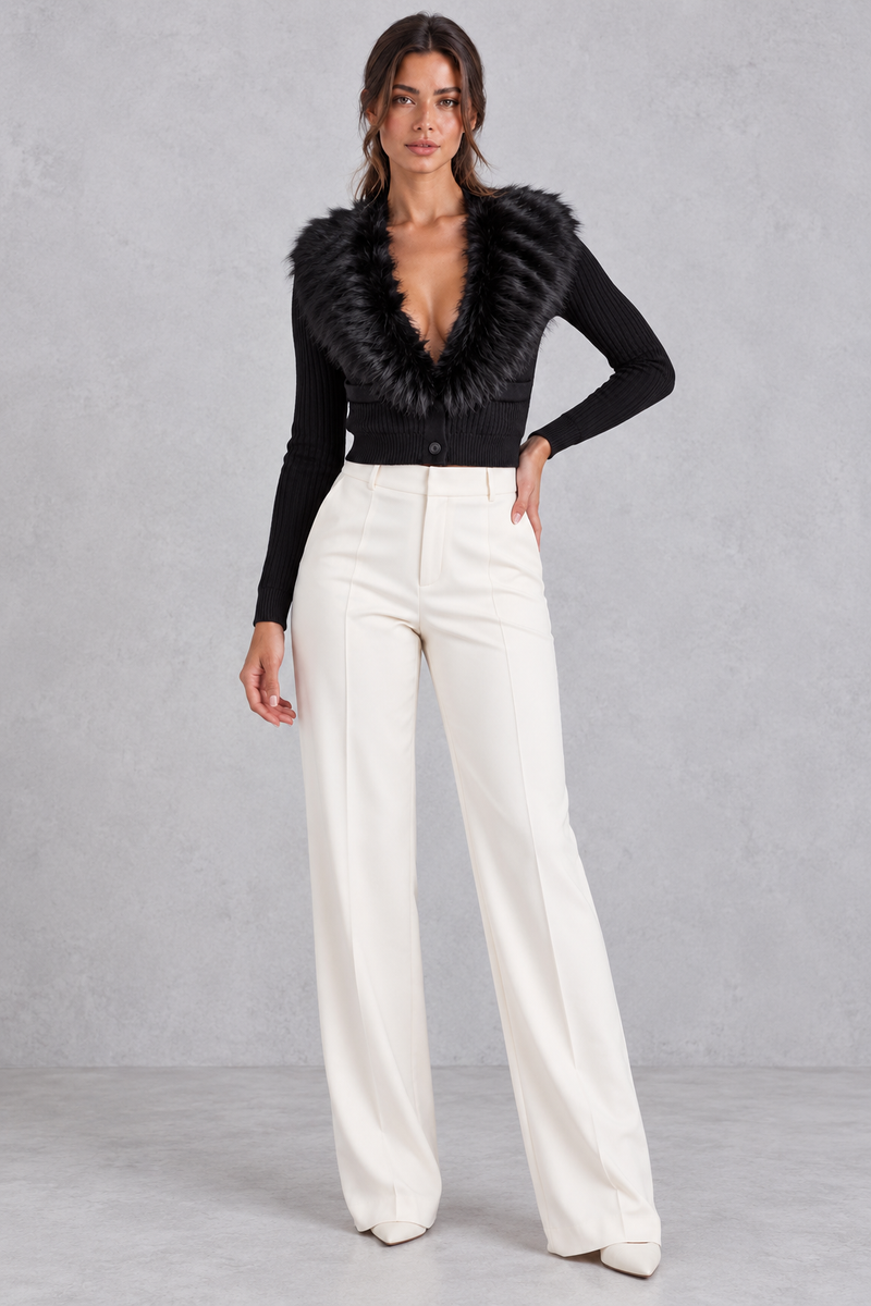 Women’s ribbed knit cardigan with a plush faux fur collar, deep V-neckline, button front and fitted cropped silhouette.