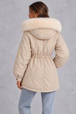 Women’s hooded parka coat with soft faux fur trim, an adjustable drawstring waist, long sleeves and a longer curved hem.