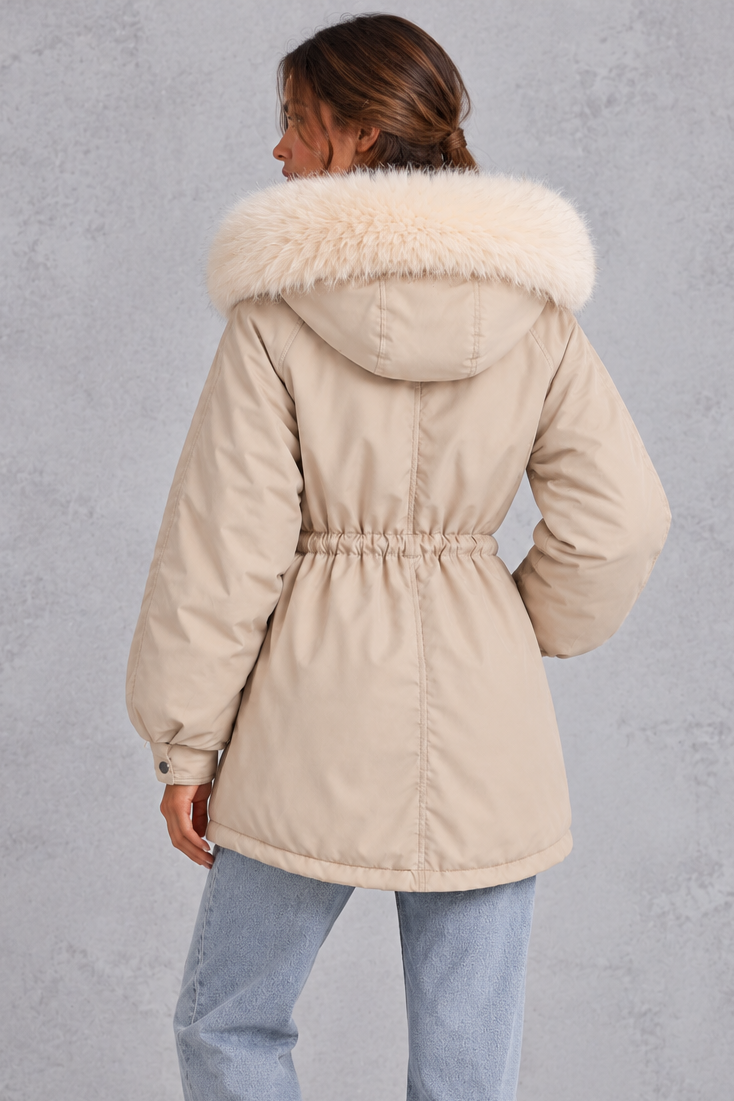 Women’s hooded parka coat with soft faux fur trim, an adjustable drawstring waist, long sleeves and a longer curved hem.